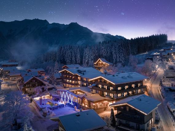 Hotel Gassner **** Superior illuminated in a snowy alpine village beneath a starry sky
