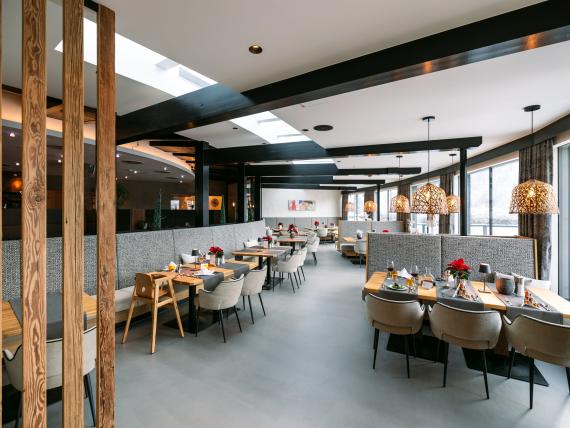 Modern restaurant at Familienresort Buchau with set tables and cozy atmosphere