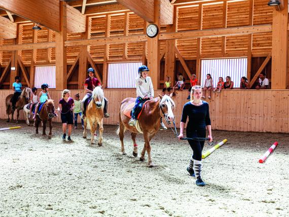 Children pony riding in the arena at Familienresort Buchau