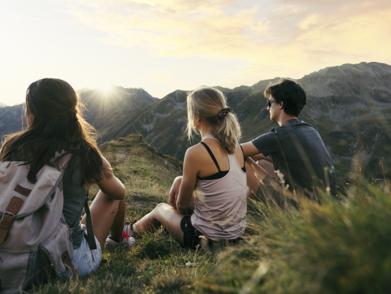 People relaxing at sunset in the mountains at Forster's Naturresort