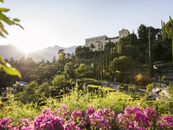 Hotel Adria with garden and mountains at sunset