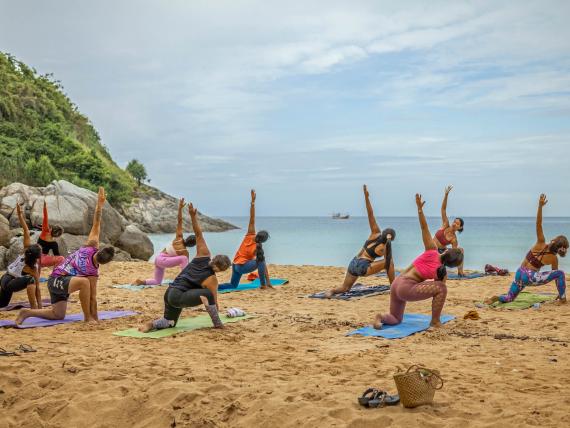 Yoga on beach at sunrise The Mangosteen Ayurveda & Wellness Resort