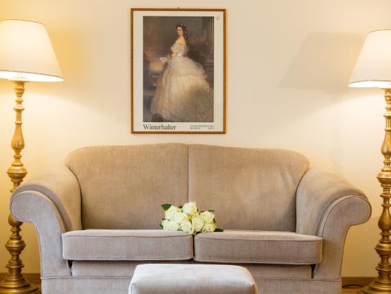Cozy seating area with sofa and floor lamps at Hotel Adria