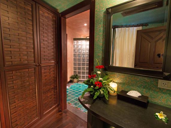 Interior of The Mangosteen Ayurveda & Wellness Resort with wooden closet and floral decor