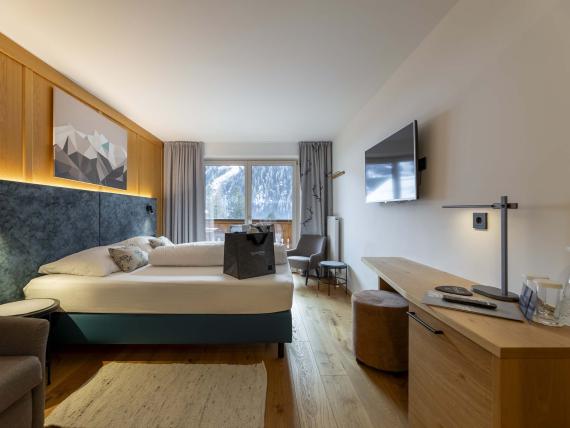 Camera dell'Unterrain Lifestyle Hotel con letto, zona salotto e vista dalla finestra
