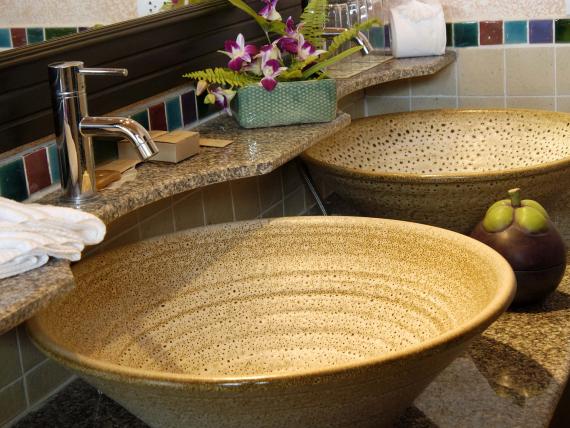 Decorative sinks and flowers at The Mangosteen Ayurveda & Wellness Resort bathroom
