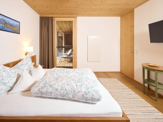 Modernes Schlafzimmer im Hochfeldhof mit Holzdecke und großem Bett