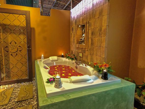 Luxury bathtub with flower petals inside The Mangosteen Ayurveda & Wellness Resort