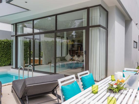 Outdoor pool and dining area at The Mangosteen Ayurveda & Wellness Resort