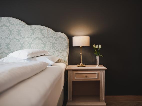 Cozy Hotel Adria room with stylish bedside table and lamp