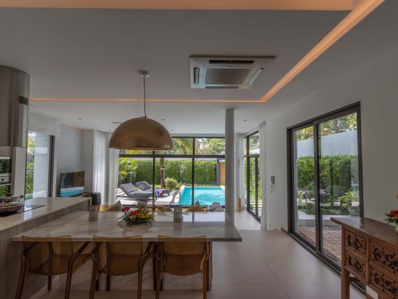 Modern dining area at The Mangosteen Ayurveda & Wellness Resort with pool views
