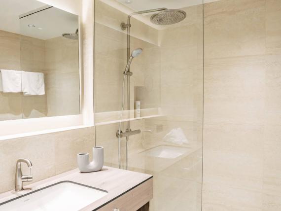 Modern bathroom with shower and sink at Krumers Alpin