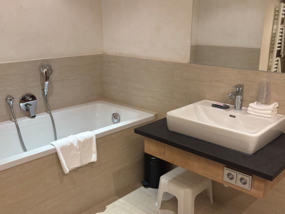 Modern bathroom with bathtub in Familienresort Buchau