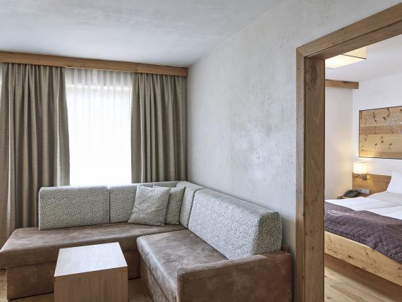 Brightly furnished bedroom at Familienresort Buchau with large windows and modern design