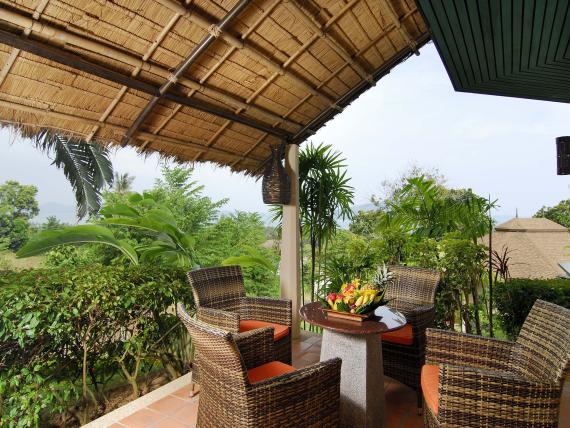 Patio with rattan chairs at The Mangosteen Ayurveda & Wellness Resort