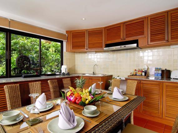 Dining area with tropical fruit centerpiece at The Mangosteen Ayurveda & Wellness Resort kitchen