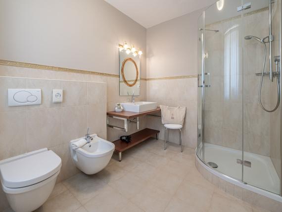 Modern bathroom at Hotel Adria with shower, toilet, and bidet