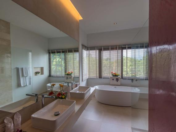 Modern bathroom with bathtub and double sink at The Mangosteen Ayurveda & Wellness Resort
