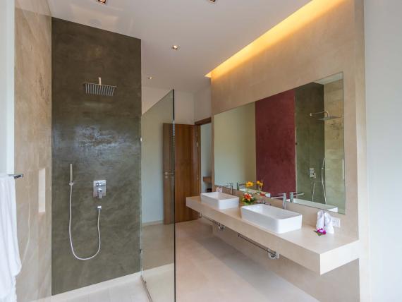 Modern bathroom with shower at The Mangosteen Ayurveda & Wellness Resort.