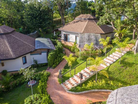 The Mangosteen Ayurveda & Wellness Resort with round villas and lush green gardens