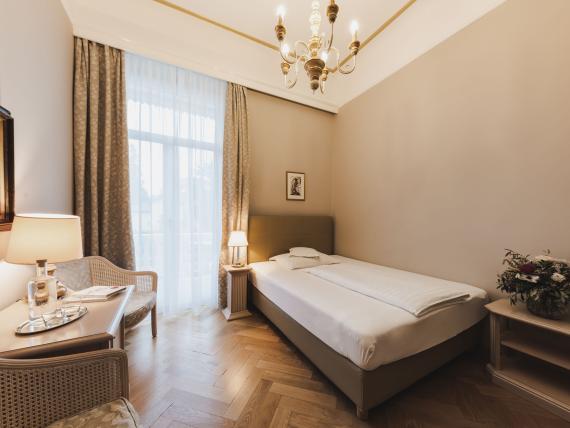 Cozy single room at Hotel Adria with classic furniture and bed