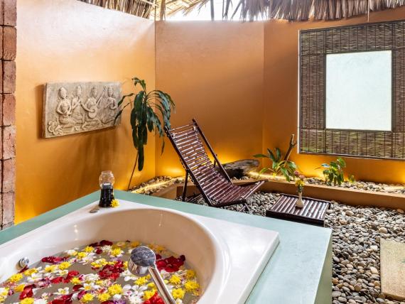 Outdoor bath area at The Mangosteen Ayurveda & Wellness Resort with relaxing decor.