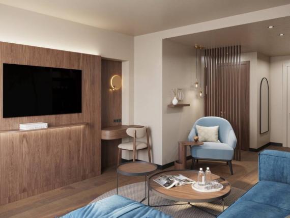 Cozy living area at Krumers Alpin with blue chairs and wooden accents
