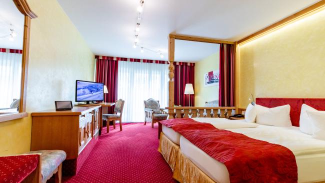 Gemütliches Zimmer im Pfalzblick Wald Spa Resort mit Doppelbett und TV