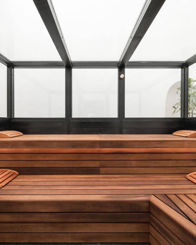 Modern Schwarzer Adler sauna room with wooden benches and glass walls