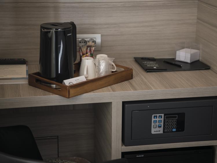 Coffee machine and safe in the room at Hotel Touring Verona