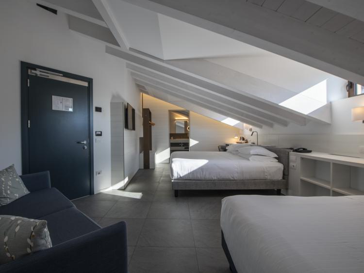 Modern hotel room with slanted ceiling at Hotel Touring Verona