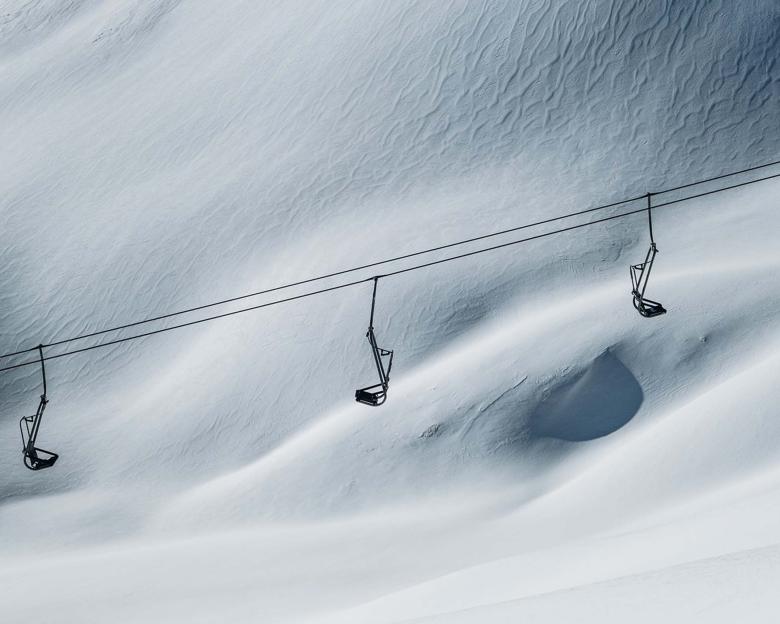 Empty ski lifts above snowy slope at Hotel Aurora