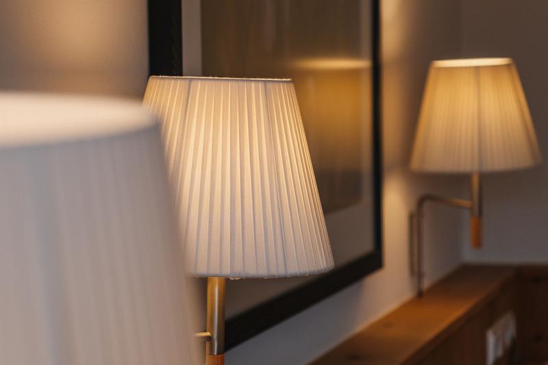 Lit wall lamps and artwork in a room at Hotel Aurora
