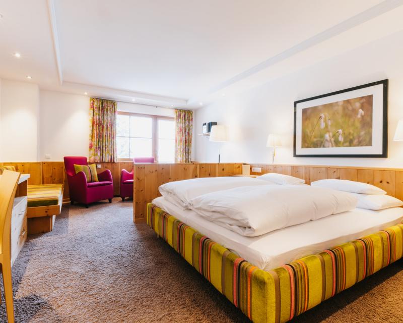 Cozy wall lamp and pillow at Hotel Aurora