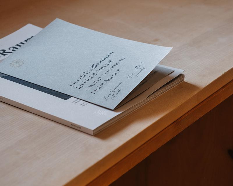 Hotel Aurora information brochures on a wooden table
